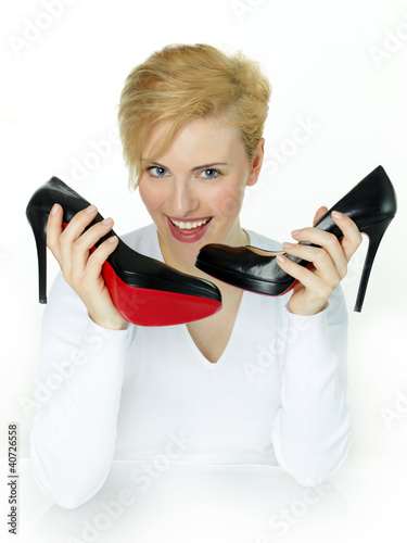 Foto: Young female is happy to have a pair of High Heels Young female is happy to have a pair of High Heels