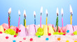 Birthday cake with candles on blue background