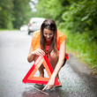 Young female driver after her car has broken down