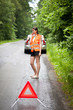 Young female driver after her car has broken down