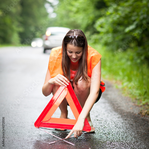 Photo: Young female driver after her car has broken down Young female driver after her car has broken down