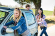 Pushing car technical failure young friends road
