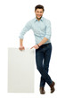 Businessman standing with blank billboard