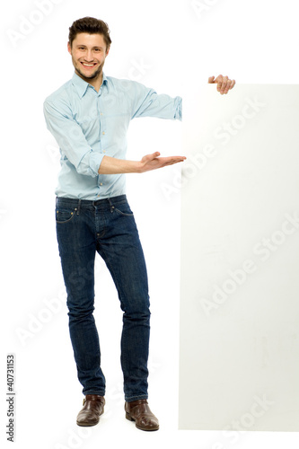 Photo: Businessman standing with blank billboard Businessman standing with blank billboard