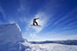 Amateur snowboarder making a grab in big air jump.