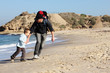 Dad, son and daughter during a walk along the sea running from t