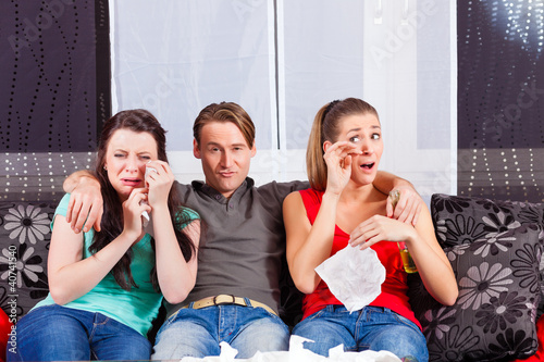 Photo: Friends watching a sad movie in TV Friends watching a sad movie in TV