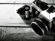 Vintage 35 mm film photo camera over wooden desk
