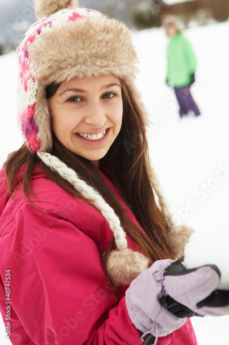 Photo: Teenage Couple Having Snowball Fight Wearing Fur Hats Teenage Couple Having Snowball Fight Wearing Fur Hats