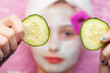Cucumber slices with a facial mud mask at a spa