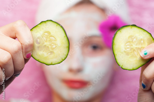 Photo: Cucumber slices with a facial mud mask at a spa Cucumber slices with a facial mud mask at a spa