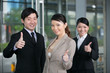 Photo: Happy business team giving thumbs up. Happy business team giving thumbs up.