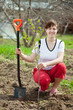 woman planting tree in orchard woman planting tree in orchard