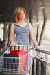 Young woman with shopping cart