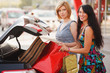 Two young shoppers on a car parking