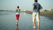Young sport couple jogging on the beach, slow motion