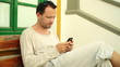 Young man sms on cell phone outdoors