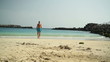 Young man walking on the beach