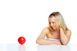 portrait of a happy woman with red ball against white background