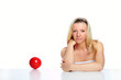 portrait of a happy woman with red ball against white background