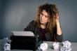 Young desperate girl writing with an old typewriter. Conceptual