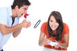 Man screaming in bullhorn while woman playing video games