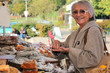 a senior woman  in an open-air market