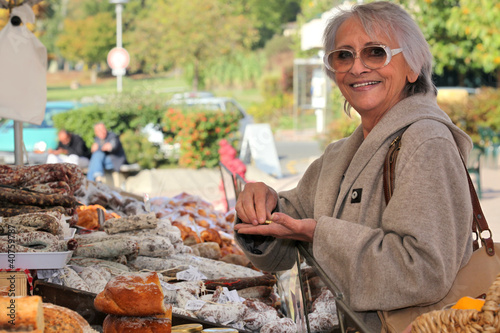 Photo: a senior woman in an open-air market a senior woman in an open-air market