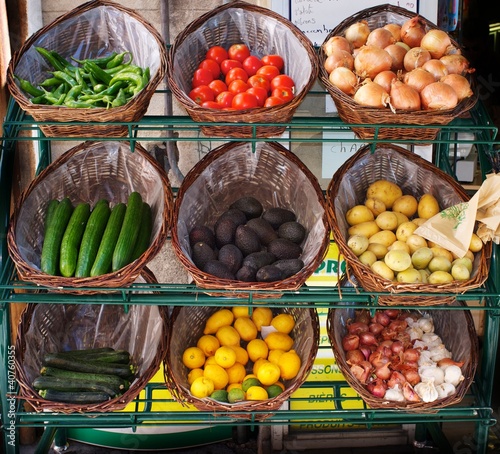 Photo: Vegetables in baskets on market place. Vegetables in baskets on market place.