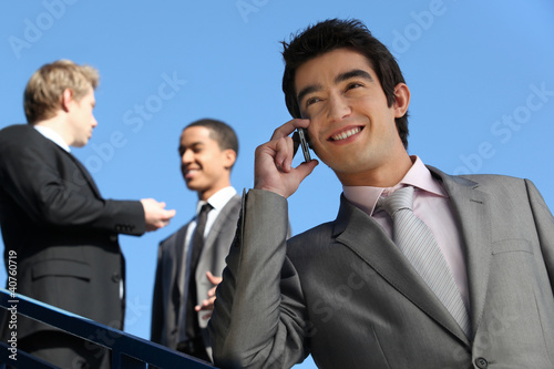 Photo: junior businessman on the phone outdoors junior businessman on the phone outdoors