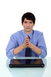 Businessman praying at desk