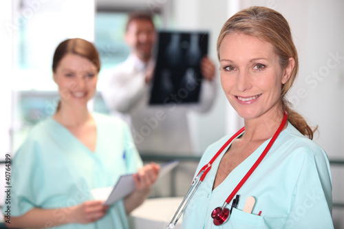 Photo: Female nurse in X-ray room. Female nurse in X-ray room.