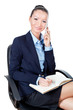 Smilling business woman sitting on chair and using mobile phone
