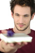 young man holding a gift