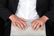 Woman typing on laptop keyboard