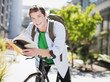 Student reading book on bicycle
