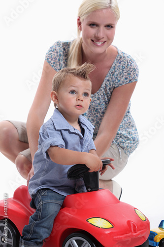 Photo: Mother and Child riding toy car Mother and Child riding toy car