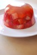 Jelly with fresh strawberries on a white dish Jelly with fresh strawberries on a white dish