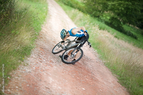 Photo: Mountain biker stopped having problem with chain of his bicycle Mountain biker stopped having problem with chain of his bicycle