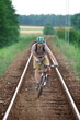 Off road biker having fun riding on railway track