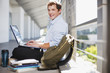 Student working on laptop on floor
