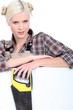 young handywoman posing with saw