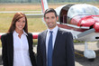 Man and woman in front of airplane