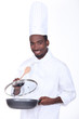 canvas print picture - black chef holding pan