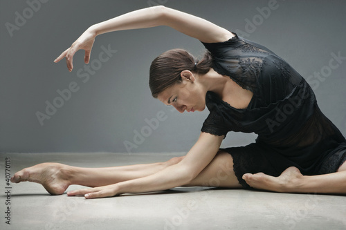 Photo: Dancer stretching on floor Dancer stretching on floor