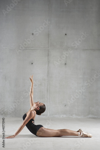 Photo: Ballet dancer posing on floor Ballet dancer posing on floor