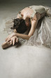 Ballet dancer posing on floor