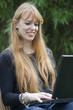Young Woman typing on a Laptop