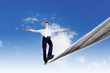Business man balancing on the rope