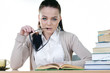 Student girl reads a book at the table